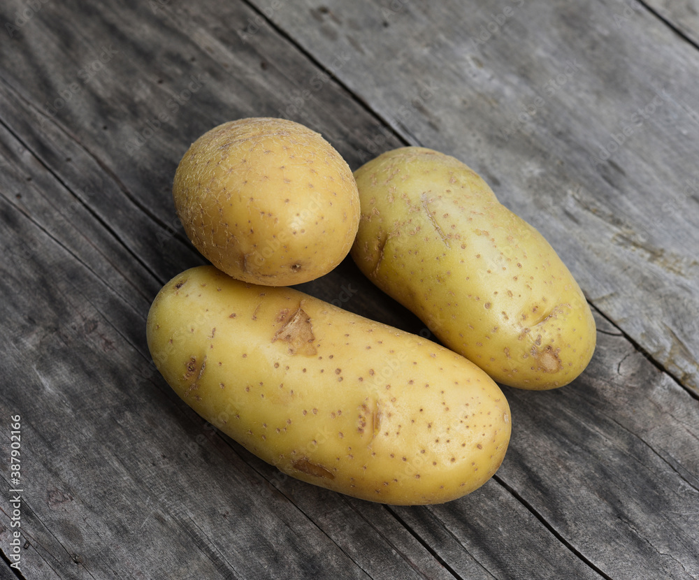 Top view of patato isolated on wooden taber background Top view of patato isolated on wooden taber background
