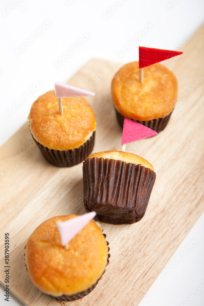 muffins with small flag on cutting board
