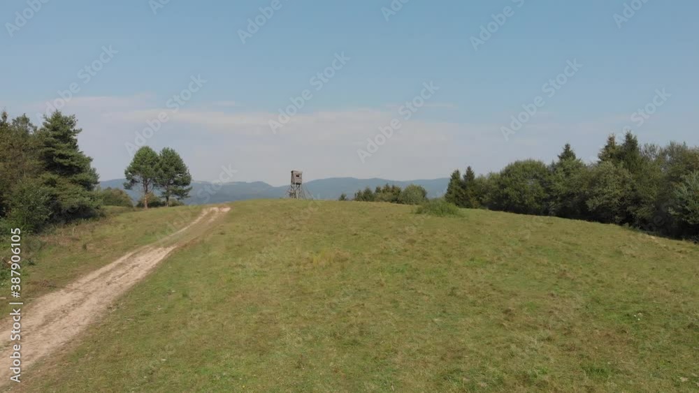 Wooden elevated hunting blind in Mountains in summer Wooden elevated hunting blind in Mountains in summer