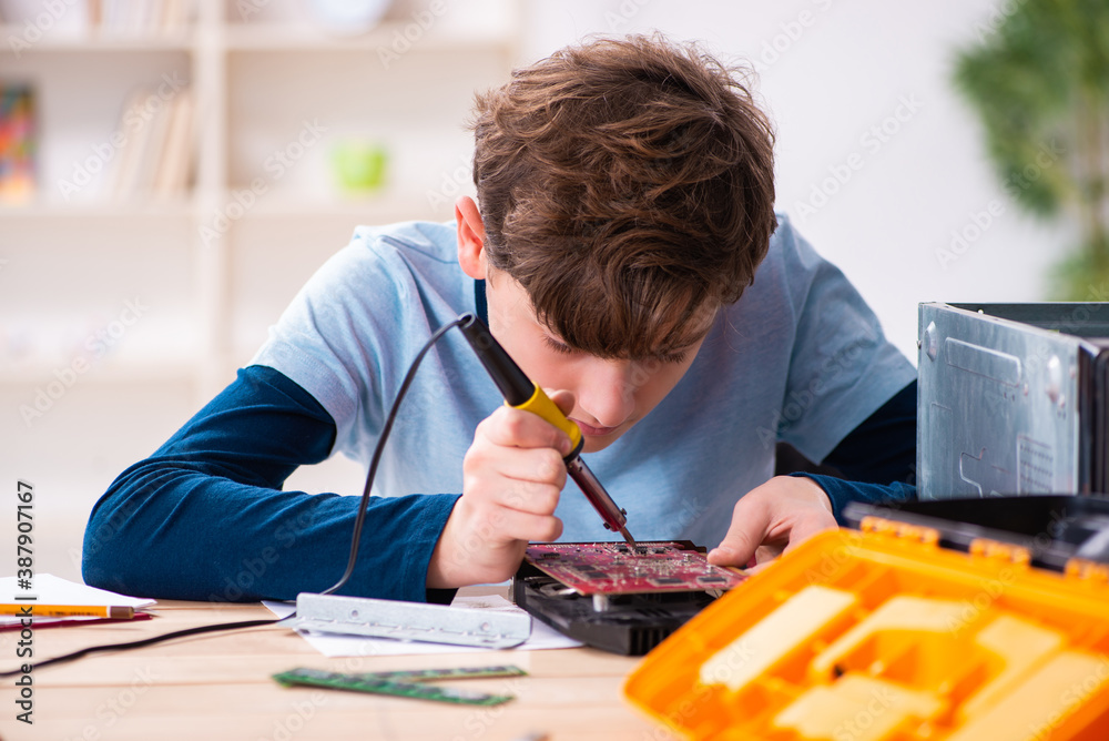 Boy reparing computers at workshop Boy reparing computers at workshop