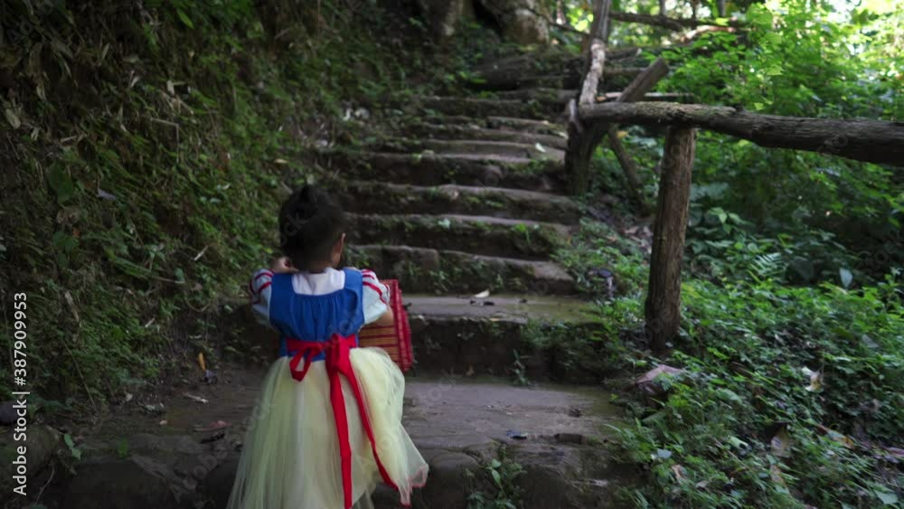 Cute little girl walking upstairs in woods. Cute little girl walking upstairs in woods.