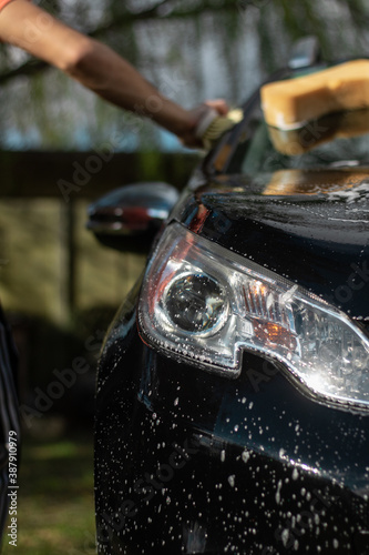 close up of a men wahing a car