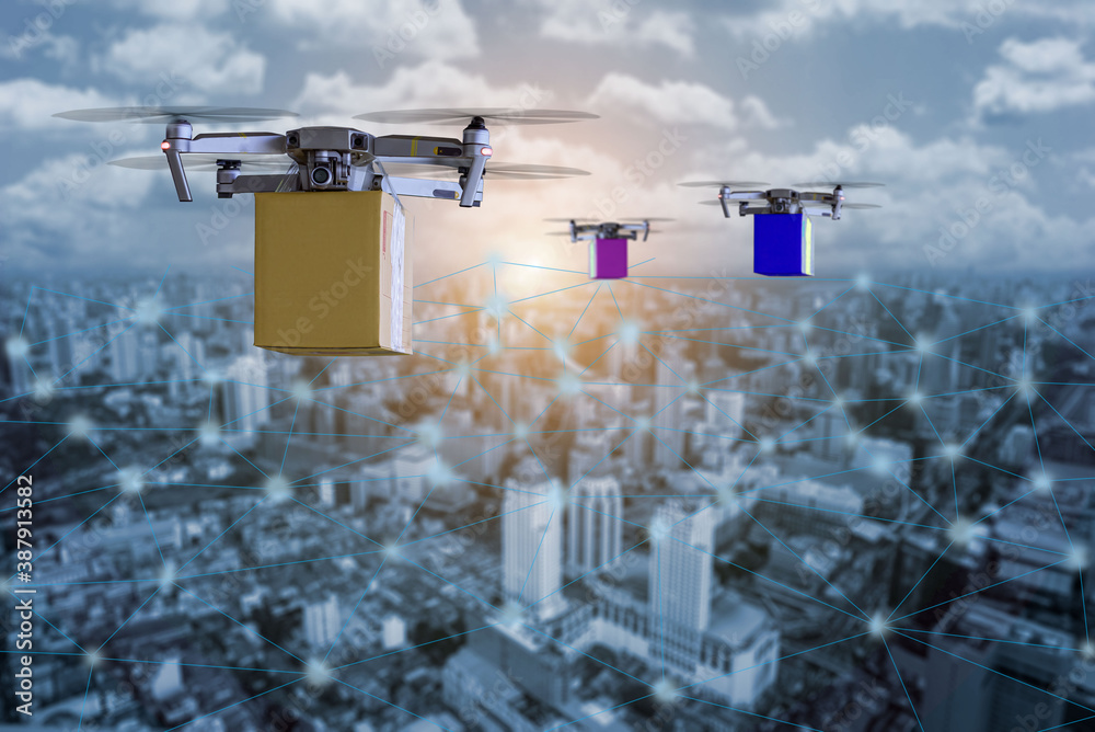 Fototapeta premium New hi technology Multicopper Drone under flying with package over the cityscape for shipment innovation drone fast delivery in city concept.