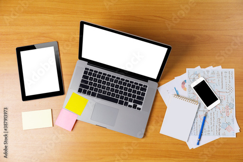 Laptop or notebook, mobilephone or smartphone, tablet with blank white screen on wood table white background save with clipping path. Laptop with empty screen for text or design.