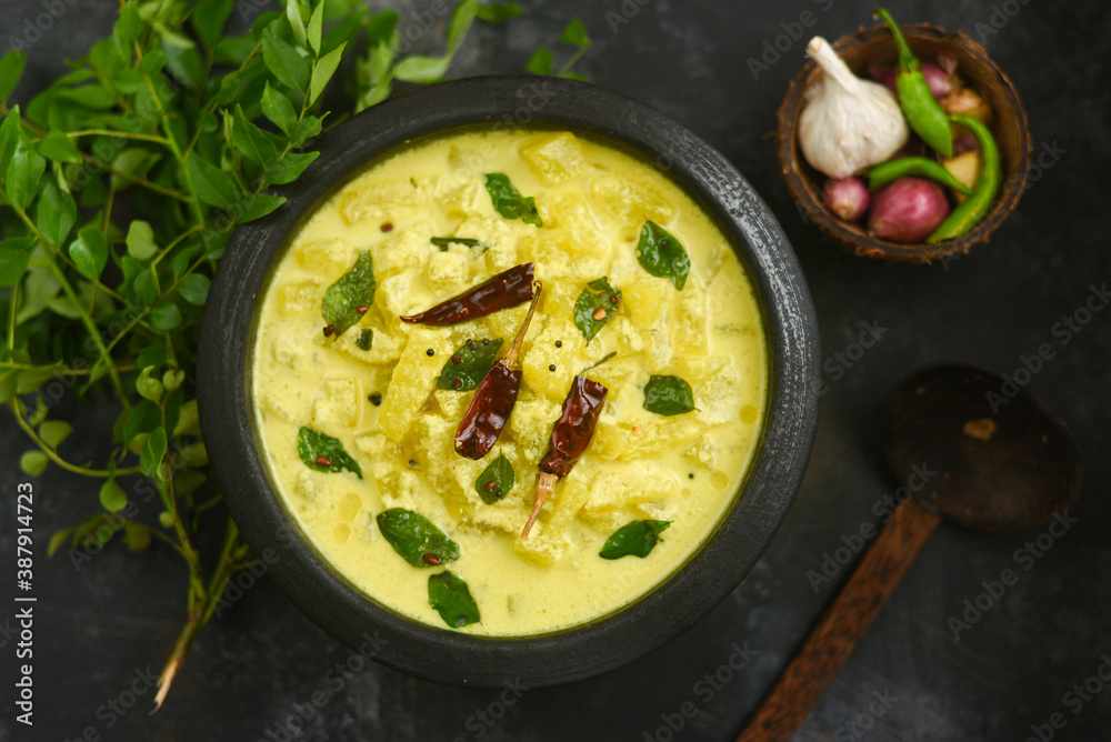 Bowl of homemade Ash gourd yellow curry spices, buttermilk sour cream curd yogurt Dahi fresh herbs curry leaf Kerala, India. Dairy product coagulating milk , curdling. probiotic food. tasty curd rice Bowl of homemade Ash gourd yellow curry spices, buttermilk sour cream curd yogurt Dahi fresh herbs curry leaf Kerala, India. Dairy product coagulating milk , curdling. probiotic food. tasty curd rice