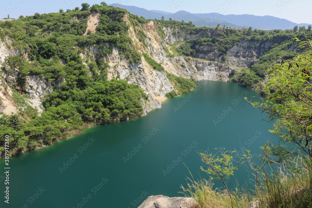 Snowy mountain views, Grand Canyon, Chon Buri, Thailand, a limestone mountain with an abandoned old earthen pit. A large ravine with emerald green water.