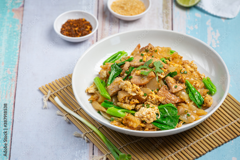 Thai food; Fried noodle with pork in soy sauce and vegetable Thai food; Fried noodle with pork in soy sauce and vegetable