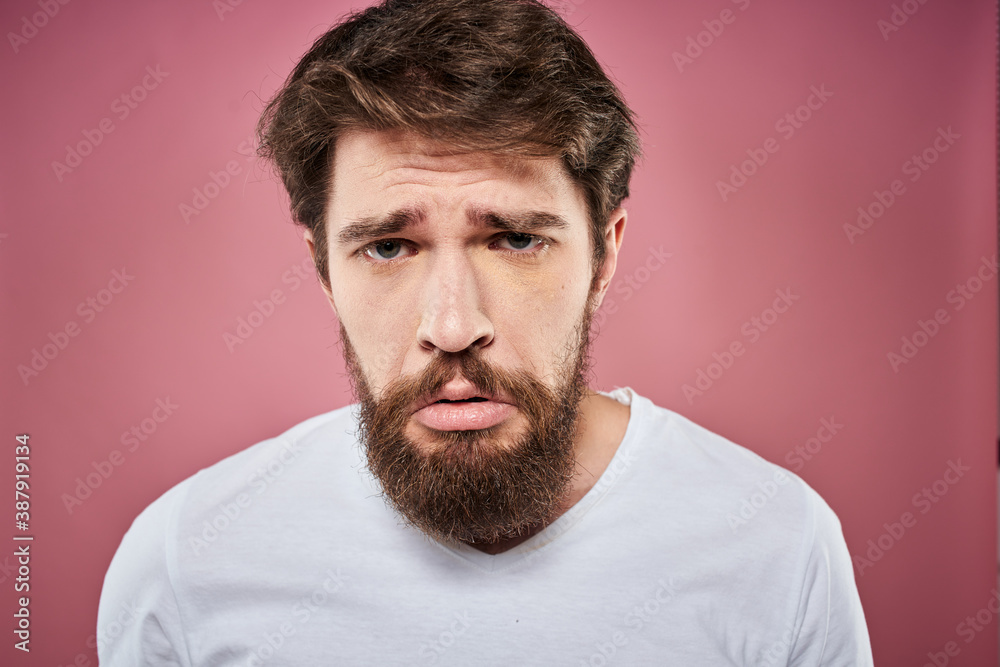 bearded man in white t-shirt emotions displeased facial expression studio pink background bearded man in white t-shirt emotions displeased facial expression studio pink background