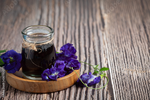 a glass of Butterfly Pea Flower tea put on wooden tray