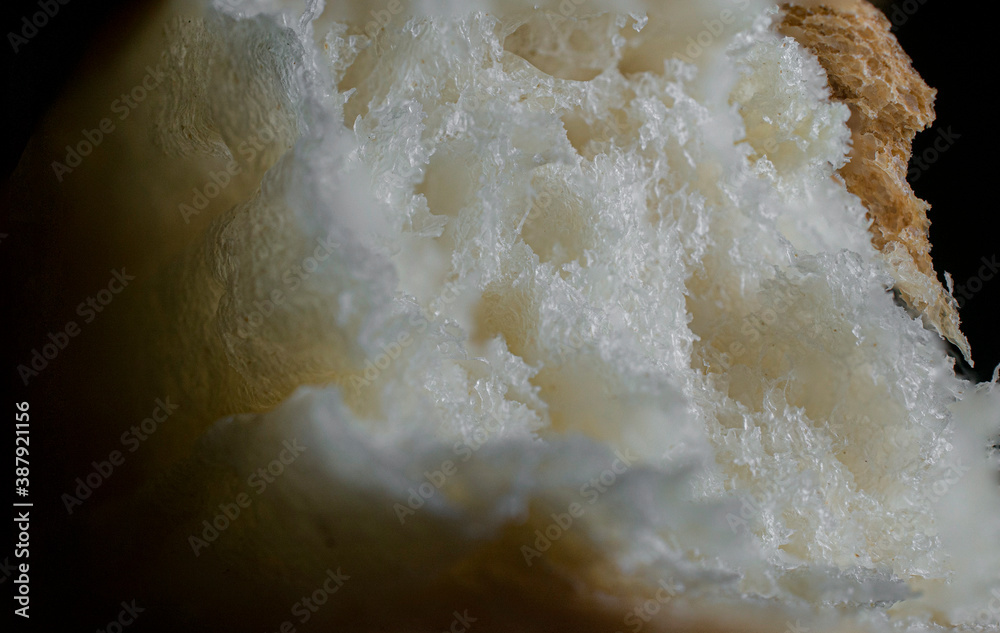 Extreme close up or macro photography, piece of bread in dark environment, dark food photography Extreme close up or macro photography, piece of bread in dark environment, dark food photography