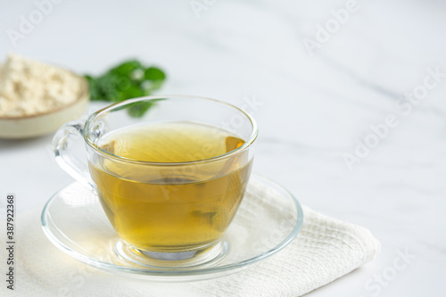 Stevia tea in a glass cup on the table