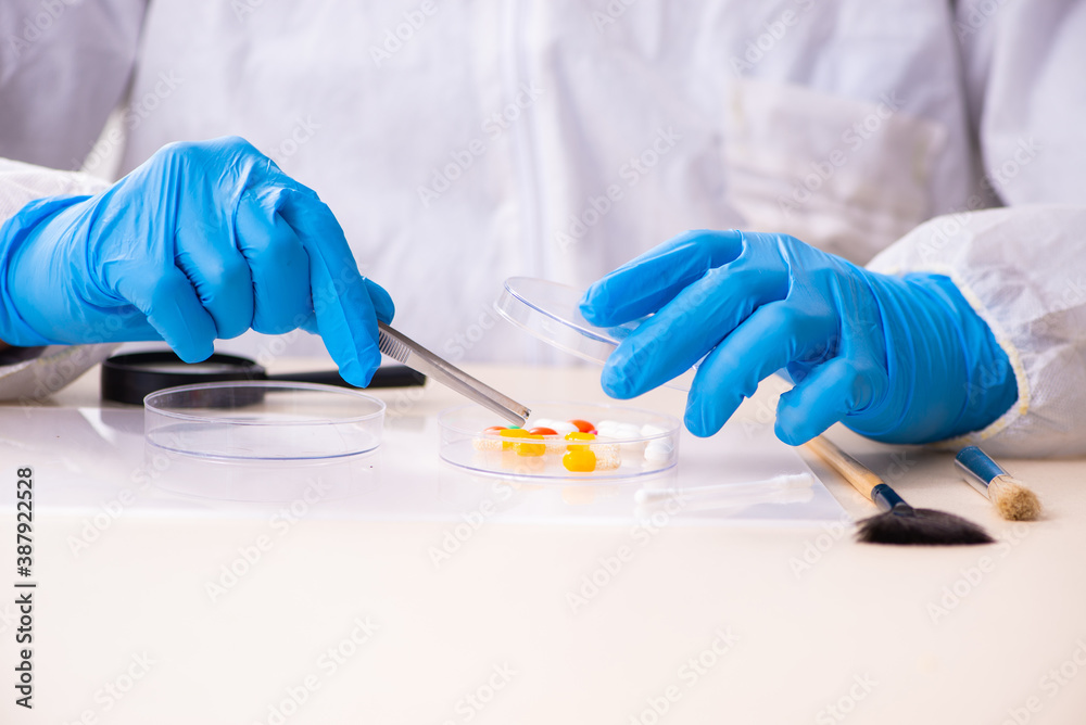 Male expert criminologist working in the lab for evidence Male expert criminologist working in the lab for evidence