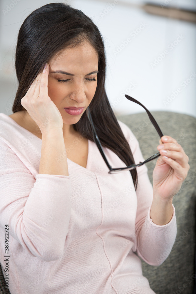 unhappy woman suffering from head ache at home unhappy woman suffering from head ache at home