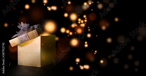 Christmas box expelling colored balls with black background