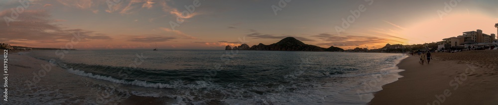 A panoramic view of one of the beaches at Cabo San Lucas, Mexico, at the tip of the Baja Peninsula, during late sunset.