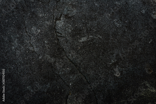 Black stone background. Cement, concrete grunge. Background blank for design. Dark gray wall texture.