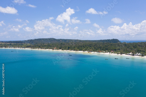 Long deserted beach with white sand and clear water. Aerial top view. island Koh Rong Samloem  Sihanoukville  Cambodia. This is a small island that attracts many vi. White sand beach and calm sea.