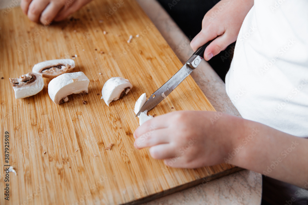 Fresh champignon mushrooms on a wooden board.