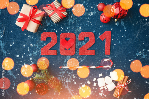 Beautiful New Year composition with figure 2021 on color background
