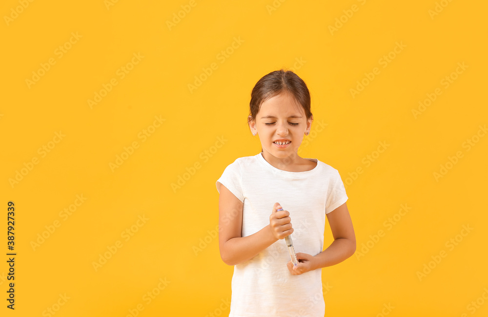Little diabetic girl taking blood sample on color background Little diabetic girl taking blood sample on color background