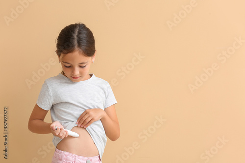 Little diabetic girl giving...