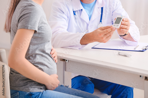 Pregnant diabetic woman visiting doctor in clinic