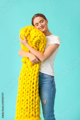 Happy young woman with warm...