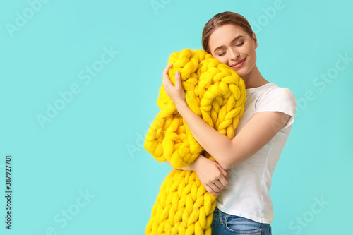Happy young woman with warm...