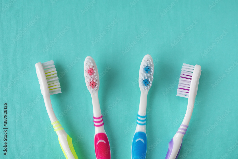 Clean toothbrushes of different colors on a blue background Clean toothbrushes of different colors on a blue background