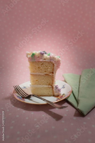 Floral frosted layer cake on pink background