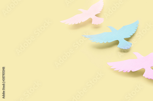 Paper doves on color background. International Day of Peace