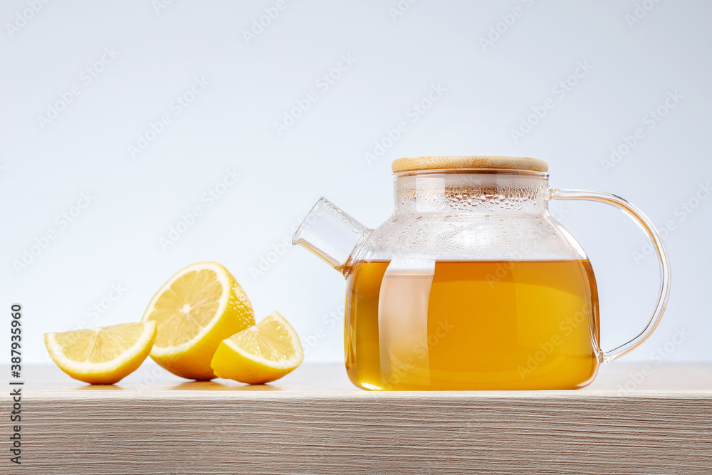 Teapot of green tea and lemon on rustic wooden table. Healthy drink. Teapot of green tea and lemon on rustic wooden table. Healthy drink.