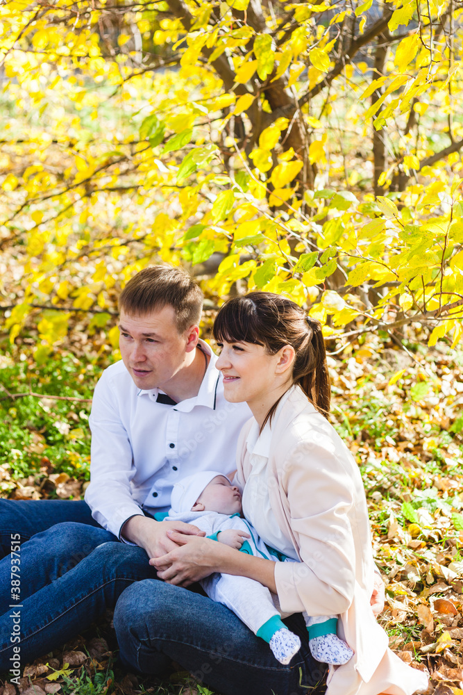 Mom and dad with a baby, a little boy walking in the fall in the Park or forest. Yellow leaves, the beauty of nature. Communication between a child and a parent. Mom and dad with a baby, a little boy walking in the fall in the Park or forest. Yellow leaves, the beauty of nature. Communication between a child and a parent.