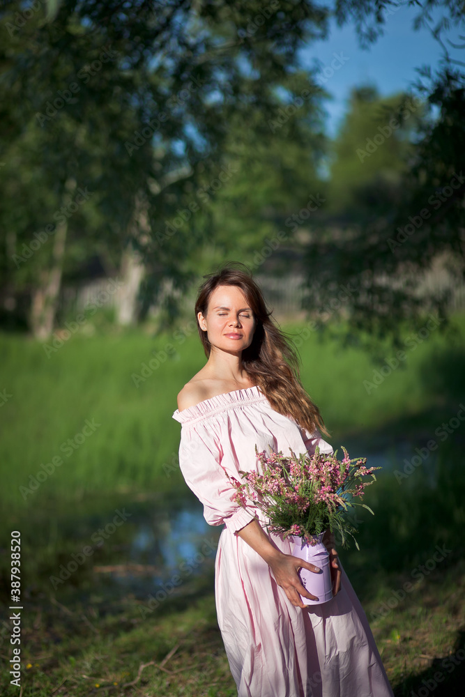 beautiful girl in a pink dress walks with a bouquet of pink flowers, a photo session in a fairy-tale style at sunset beautiful girl in a pink dress walks with a bouquet of pink flowers, a photo session in a fairy-tale style at sunset