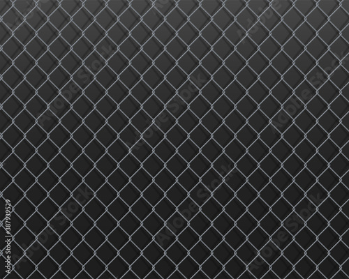 Wire mesh fence on a dark metal background.