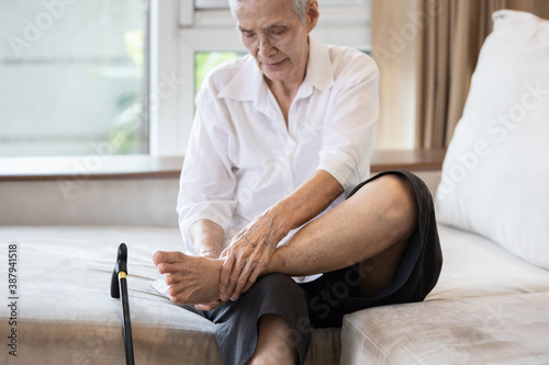 Old elderly with foot injuries,ankle bone diseases,heel pain or soles,asian senior woman suffering from peripheral neuropathy,beriberi,nerve inflammation of the foot, numbness of the feet and toe