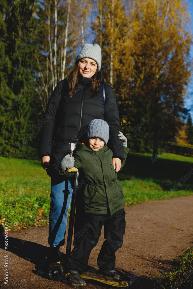 mom and son on a walk in the park.