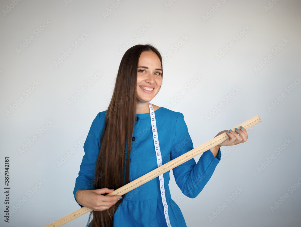 portrait of a young beautiful seamstress in blue dress portrait of a young beautiful seamstress in blue dress