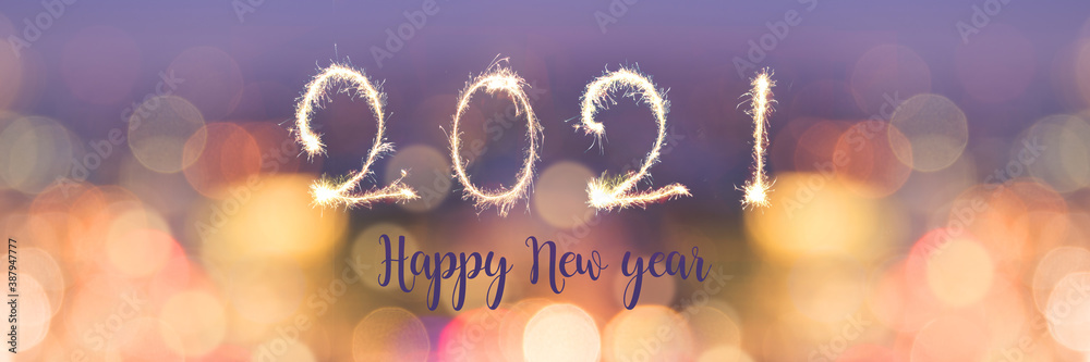 Happy new year 2021 written with sparkles on panoramic banner of blurred bokeh holiday lights at night - obrazy, fototapety, plakaty 