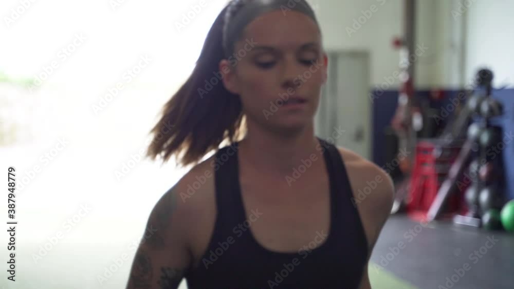 Female athlete performing leg stretches before a workout Female athlete performing leg stretches before a workout