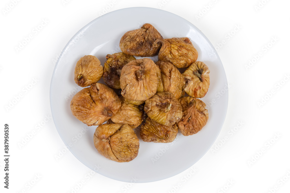 Top view of dried figs on dish on white background