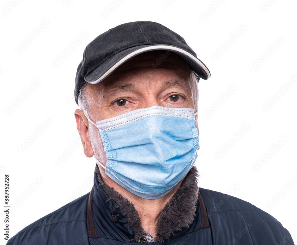Senior man in protective mask posing in studio over white background Senior man in protective mask posing in studio over white background
