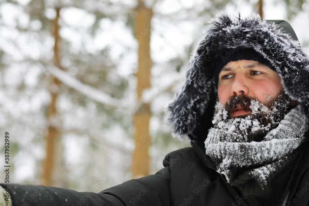 Bearded man in the winter woods. Attractive happy young man with beard walk in the park. Bearded man in the winter woods. Attractive happy young man with beard walk in the park.