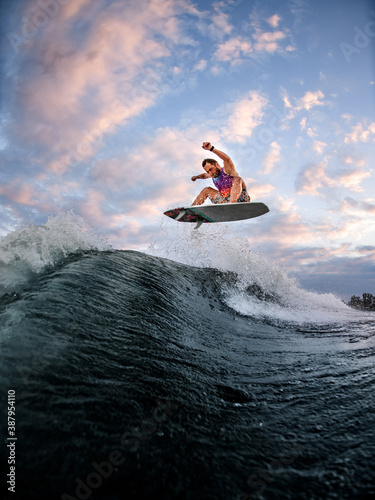 Fototapeta Naklejka Na Ścianę i Meble -  energetic man engaged in extreme water sports on the surf style wakeboard.