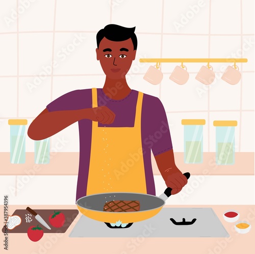 Indian black man cooking in his kitchen. male in a red shirt and green apron roasting a steak in a frying pan. salt in hand. Cartoon vector illustration