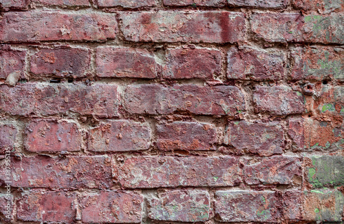 Old  weathered brickwork with crumbling plaster. Background. Vintage.