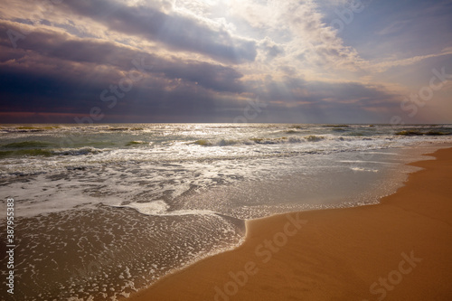 Seascape. Seashore with dramatic sky. Landscape with ocean and bright evening cloudy sky