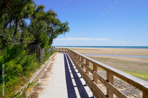 wooden pontoon walkway on sandy beach side in atlantic ocean coast horizon in Jard sur Mer in france