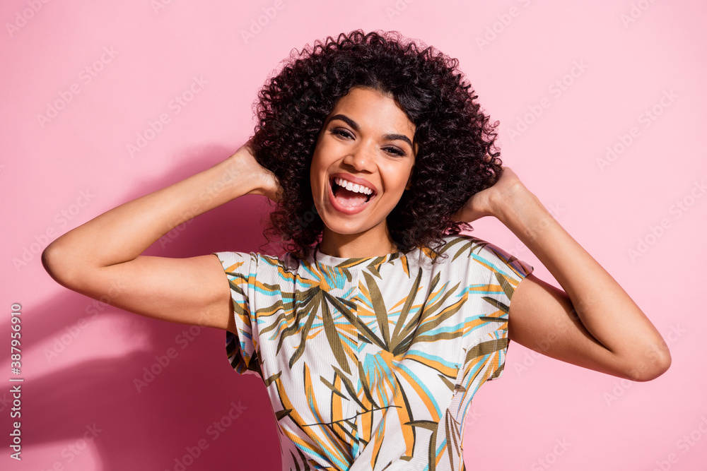 Photo portrait of woman touching hair isolated on pastel pink colored background Photo portrait of woman touching hair isolated on pastel pink colored background
