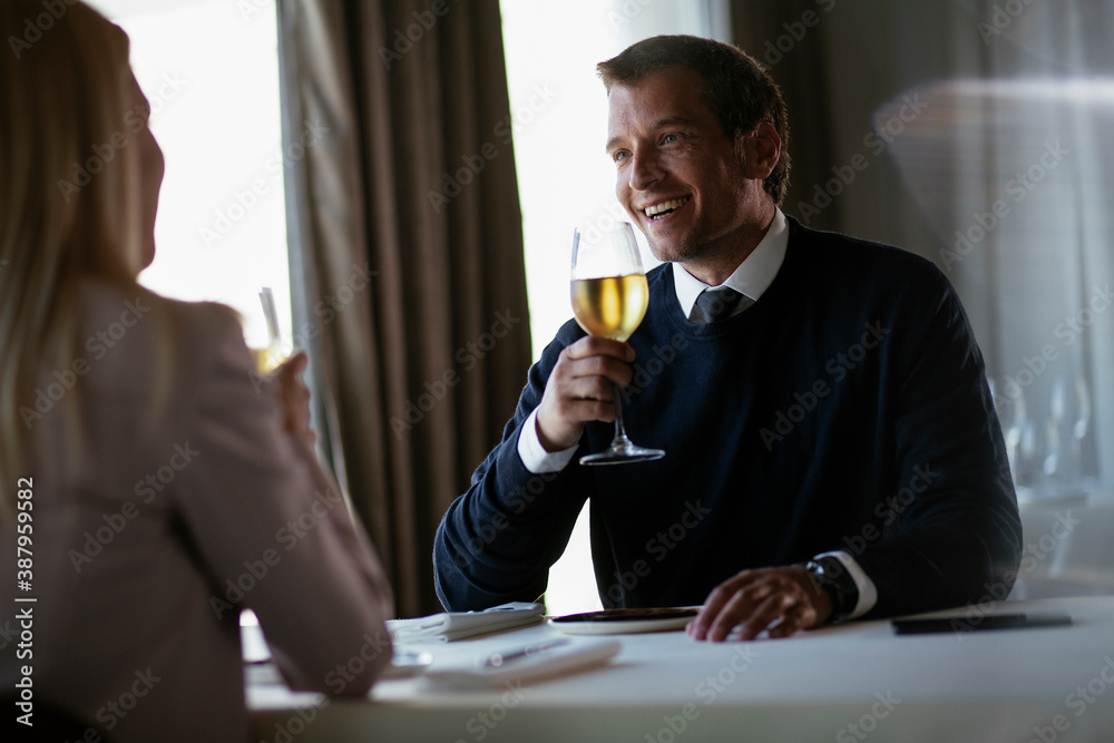 Handsome businessman drinking wine. Businessman enjoying in the restaurant